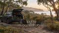 Wagon and camp chairs at a bush campsite at dawn