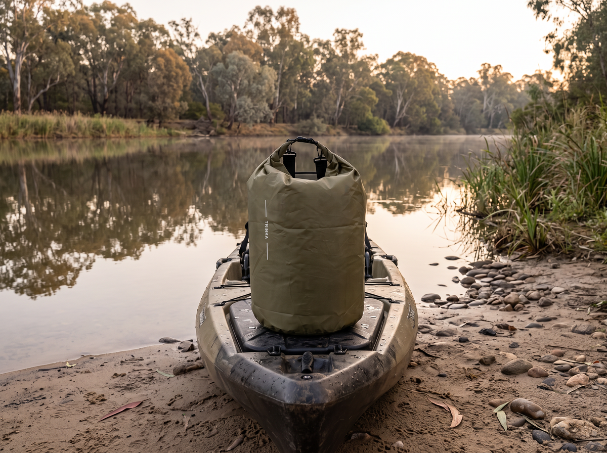 Roll-top dry bag on a kayak at a river bank