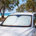 Windscreen sun shade in a parked SUV at the beach